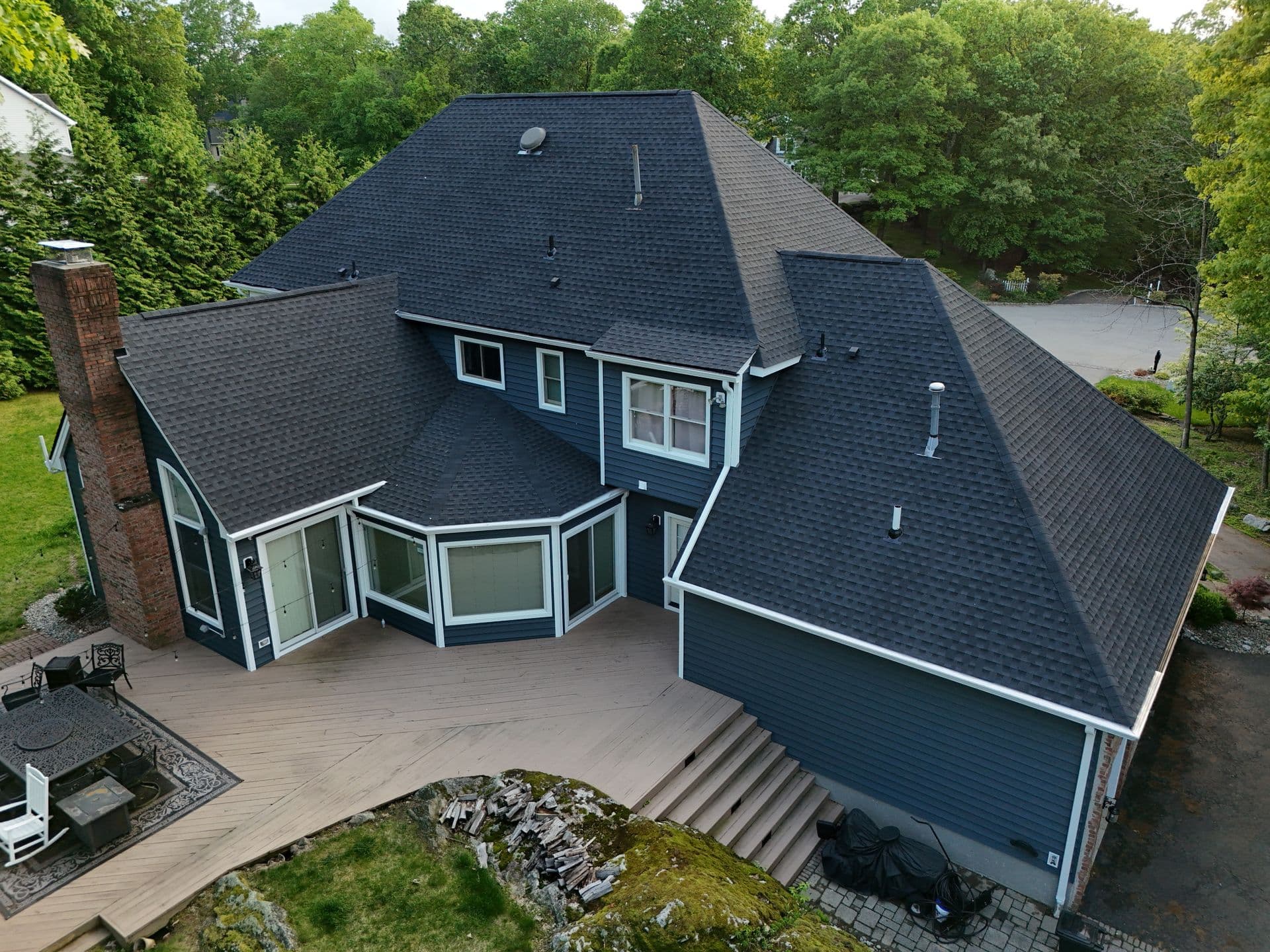 Superior Siding project — Navy siding · architectural shingle roof · multi-pitch detail