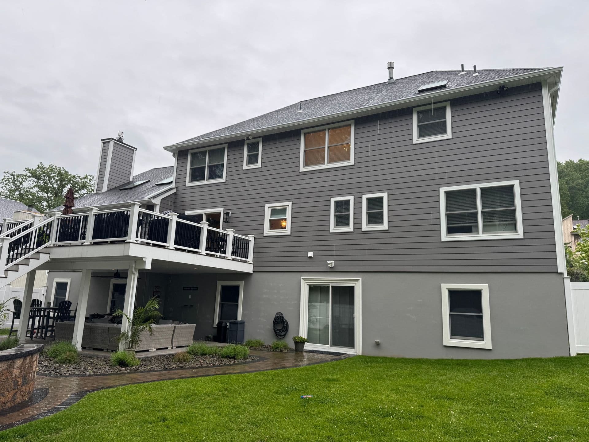 Superior Siding project — Gray siding · rear deck · two-story exterior